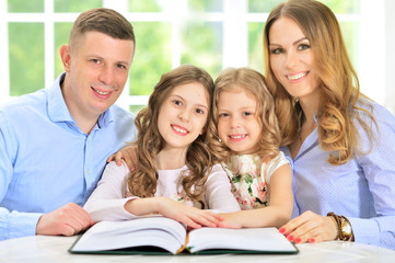 Happy family with book