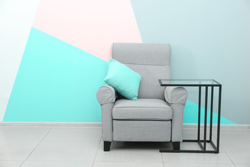 Trendy furniture near wall with mint color