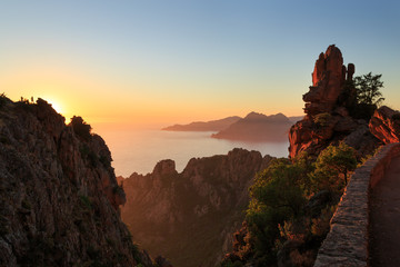 Cliffs of the famous Calanches and the Golf of Porto at the island of Corsica, France, during sunset.