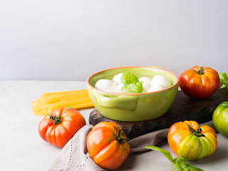Italian food tomato mozzarella still life on gray rustic background. Traditional products