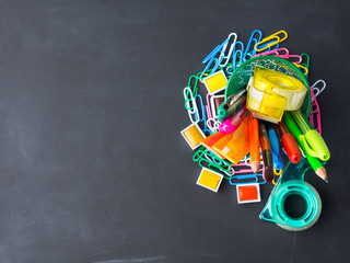 Colorful stationery back to school concept on blackboard background