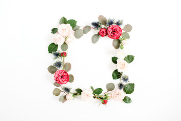 Round frame wreath made of red and beige rose flower buds, eucalyptus branches and leaves isolated on white background. Flat lay, top view. Floral background