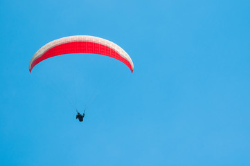 Paraglider flies paraglider in the sky. Paragliding.