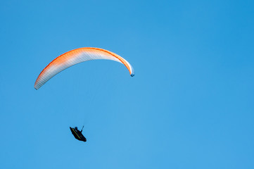 Paraglider flies paraglider in the sky. Paragliding.