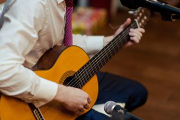 Fototapeta premium Handsome young men playing guitar