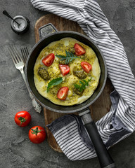 Homemade omelette with pesto sauce and mozzarella cheese
