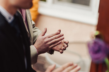 people applauding, clapping hands at wedding reception or meeting
