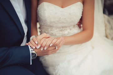 Holding hands. Closeup view of married couple holding hands