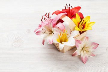 Obraz na płótnie Canvas Colorful lily flowers basket