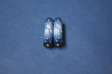 two batteries on a blue background