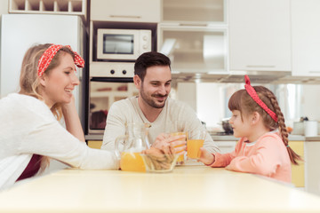 Obraz na płótnie Canvas Happy family having breakfast in kitchen