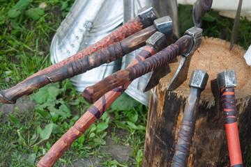 Several old battle axe stuck in the stump.