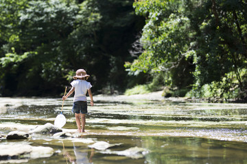 Fototapeta premium Happy Little Girl playing in the river