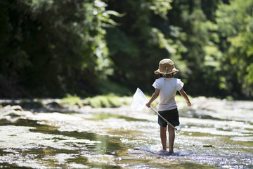 Happy Little Girl playing in the river