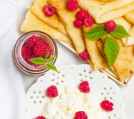 Homemade pancakes with honey, raspberries, cottage cheese with powder sugar. Flat lay, top view. copy space. eco style
