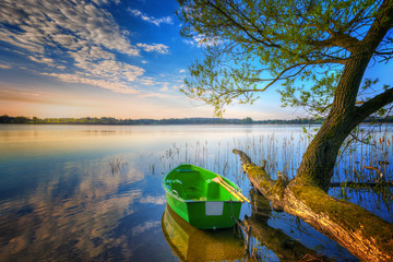 Rowing boat floating over the Lake Selment Wielki waters. Masuria, Poland.