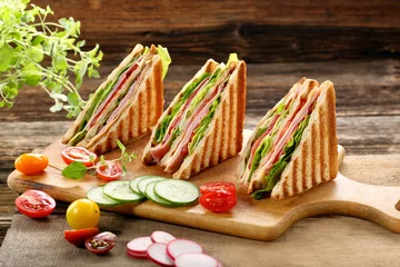 Deurstickers Fresh sandwiches on wooden background © wideonet