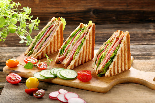Fresh sandwiches on wooden background