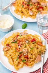 Pasta Tagliatelle with salmon fish and tomatoes