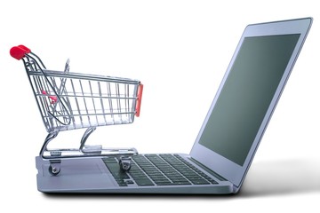 Shopping-cart over a laptop.