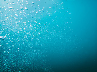 Naklejka na ściany i meble Underwater blue texture in ocean. Bubbles in tropical sea. 