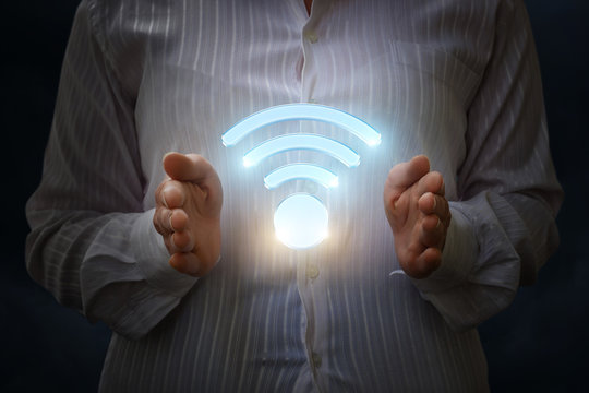 WiFi symbol in the hands of the businesswoman.