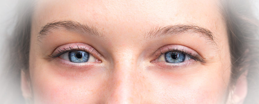 Close up of beautiful blue eyes of woman