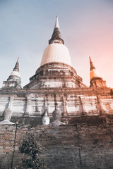 Fototapeta premium Ancient white buddha statues and ruined pagoda at Wat Yai Chai Mongkol in Ayutthaya historic attractions ,Thailand.