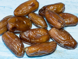 Dried date fruits on wooden background