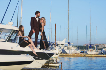 Friendship and vacation. Party on the yacht. Group of young people on the deck sailing the sea.