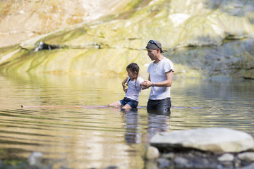 Father and daughter playing in the river