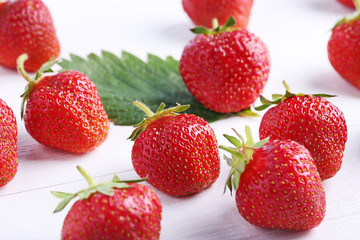 Fresh strawberries on white wooden table