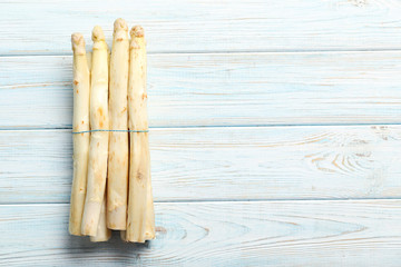 Fresh white asparagus on a blue wooden table