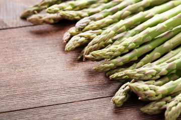 Green asparagus on brown wooden table