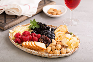 Cheese plate with nuts and berries
