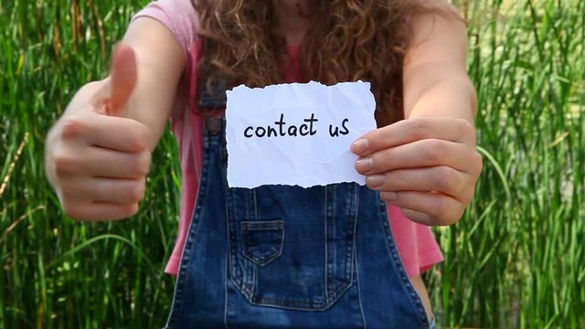Contact us - woman show words, business concept
