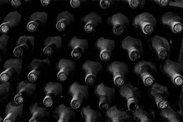 Stacked of old bottles in the cellar