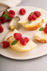 Open faced sandwiches with cheese, pears and raspberry