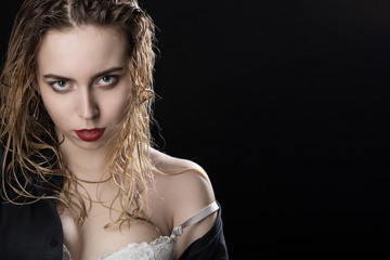 beautiful young woman with wet hair portrait looking at camera on black background with copy space
