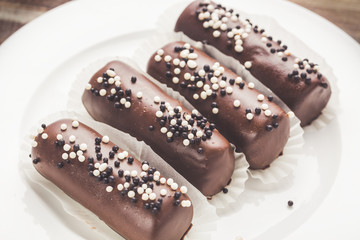 Potato chocolate cakes with sweet balls. Close up toned image with selective focus
