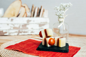 Still life of tapas appetizers sticks with cherry tomatoes, spanish jamon or ham and cheese, served for little party snack