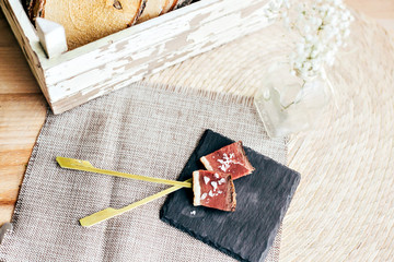 Tasty cured meat thin sliced and seasoned with sea salt and extra virgin olive oil on sticks as little tapas to snack on during wedding or party