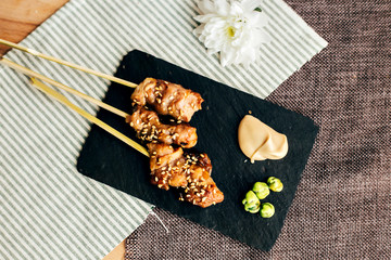 Obraz na płótnie Canvas Amazingly tasty and mouth watering sticks tapas of teriyaki chicken as yakitori traditional japanese snack