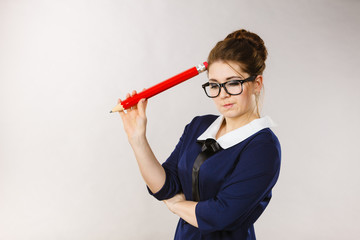 Woman confused thinking, big pencil in hand