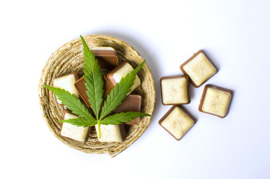 Marijuana leaf on top of chocolate pieces