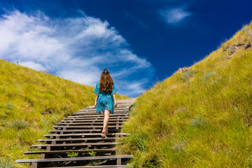 Naklejka premium Young woman climbing stairs outdoors in an idyllic travel destination from Indonesia