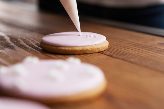 Gingerbread decorated with cream. Sweet dessert, colorful cookie, wedding present. Depth of field, selective focus. Tasty food, bakery concept