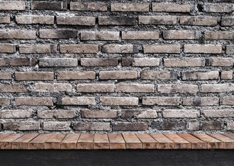 Brick wall on wooden table 