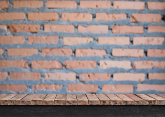 Wooden table with brick wall