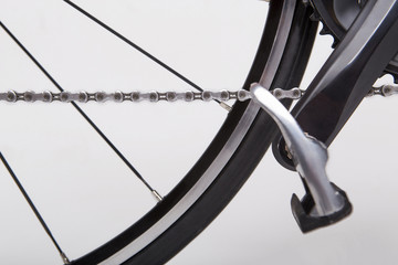 Forward. Bicycle Concept. Part of the rear wheel, gear, chain. On a white background.